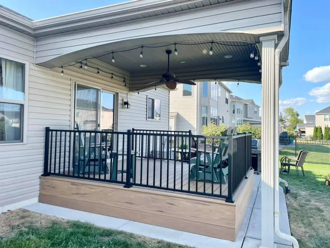 Low wooden decking with black aluminum fence.