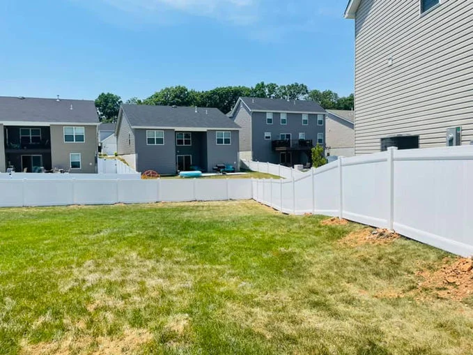 White vinyl fence in big backyard.