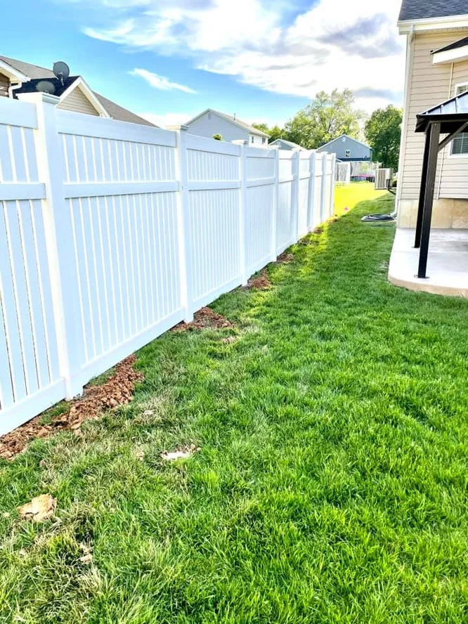 White vinyl fencing in the backyard.