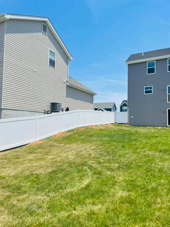 White vinyl fence, backyard view.