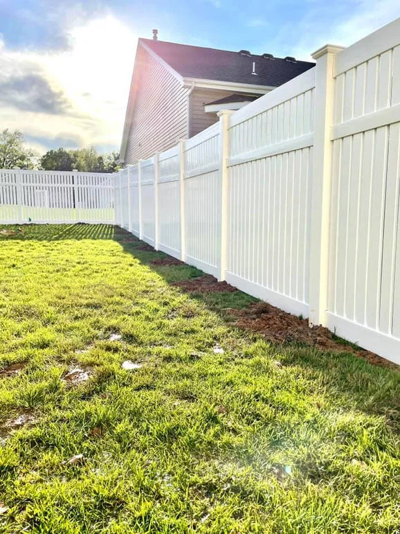White vinyl fence near house