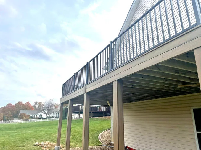 Wooden deck with black aluminum fence.