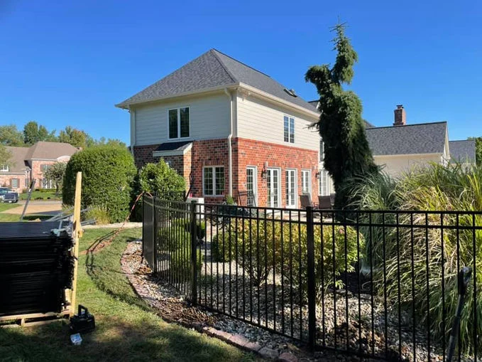 Black aluminum fence at the back of the house.