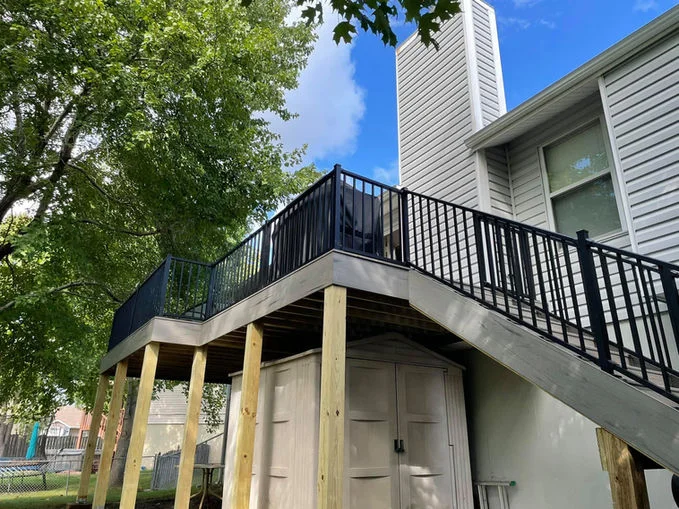 Wooden decking with stairs and black aluminum fence