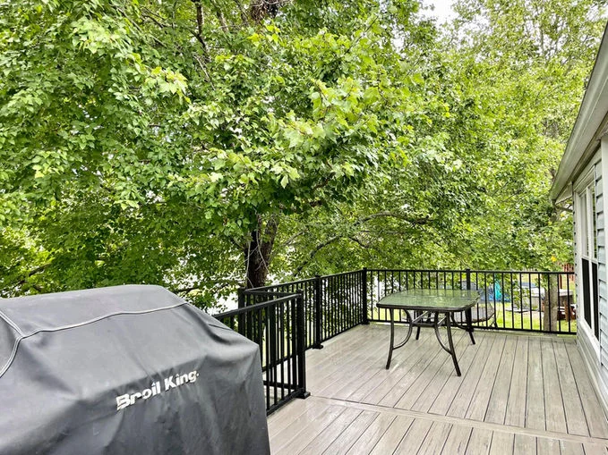 Wooden decking with black aluminum fence.