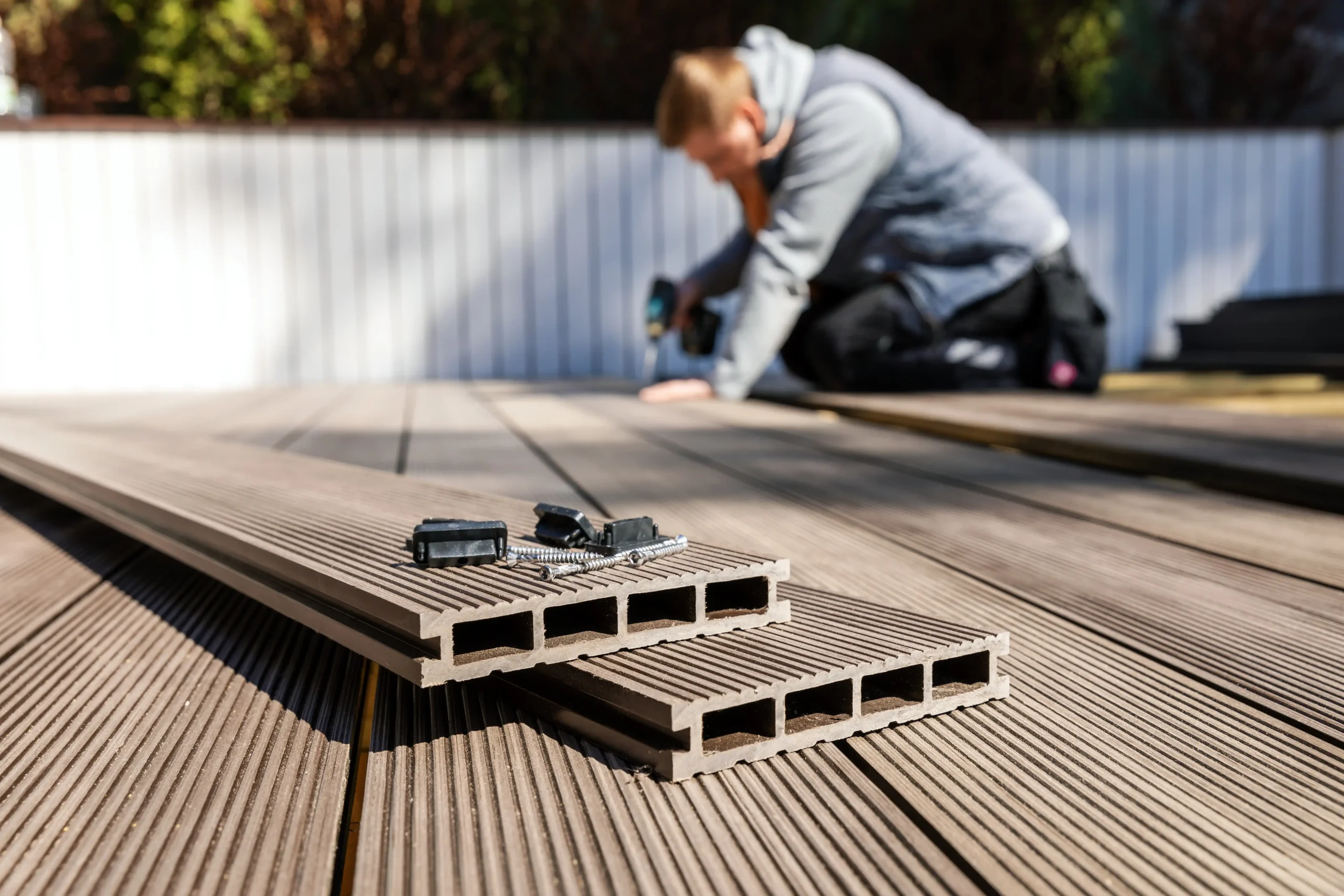 Worker installing decking.