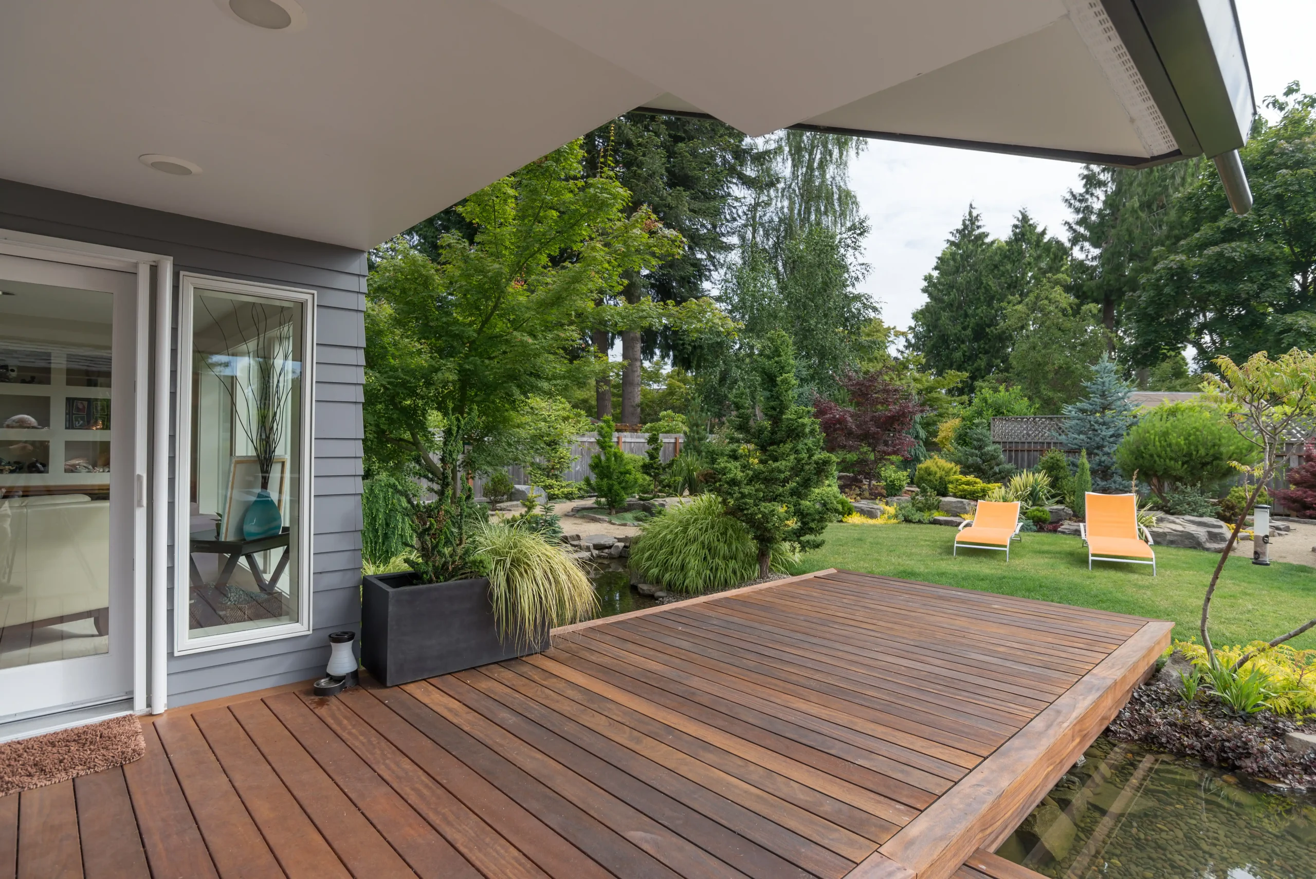 Wooden deck with backyard in sight.